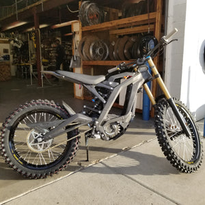 Sur Ron e-bike mounted w/ Woody's custom wheels and knobby tires