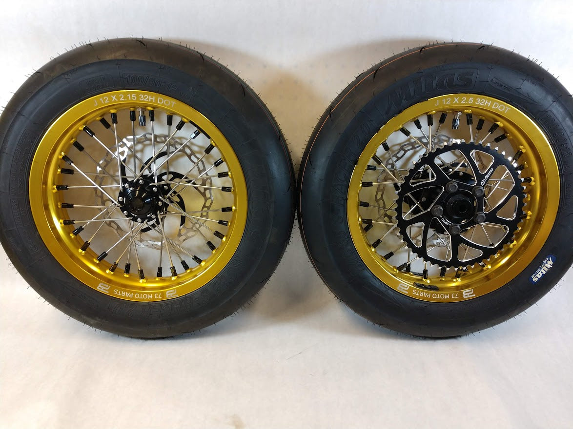 Woody's custom wheelset featuring 12" gold rims, black hubs, w/ tires rotors and sprocket mounted.