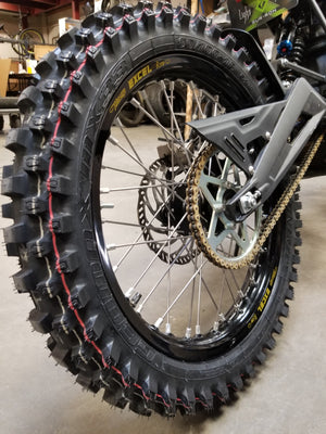 Woody's custom rear wheel mounted on Sur Ron e-bike w/ knobby tire.