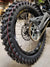 Woody's custom rear wheel w/ knobby tire, black Excel rim and black hub mounted on Sur Ron e-bike