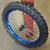 Woody's custom wheel with blue Excel rim and black hub, w/ a Knobby dirt tire mounted on the wheel