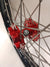 Close up of Woody's custom red billet hub for Sur Ron e-bike