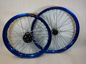 Woody's custom wheelset for Sur Ron e-bike featuring blue Excel rims w/ black billet hubs.