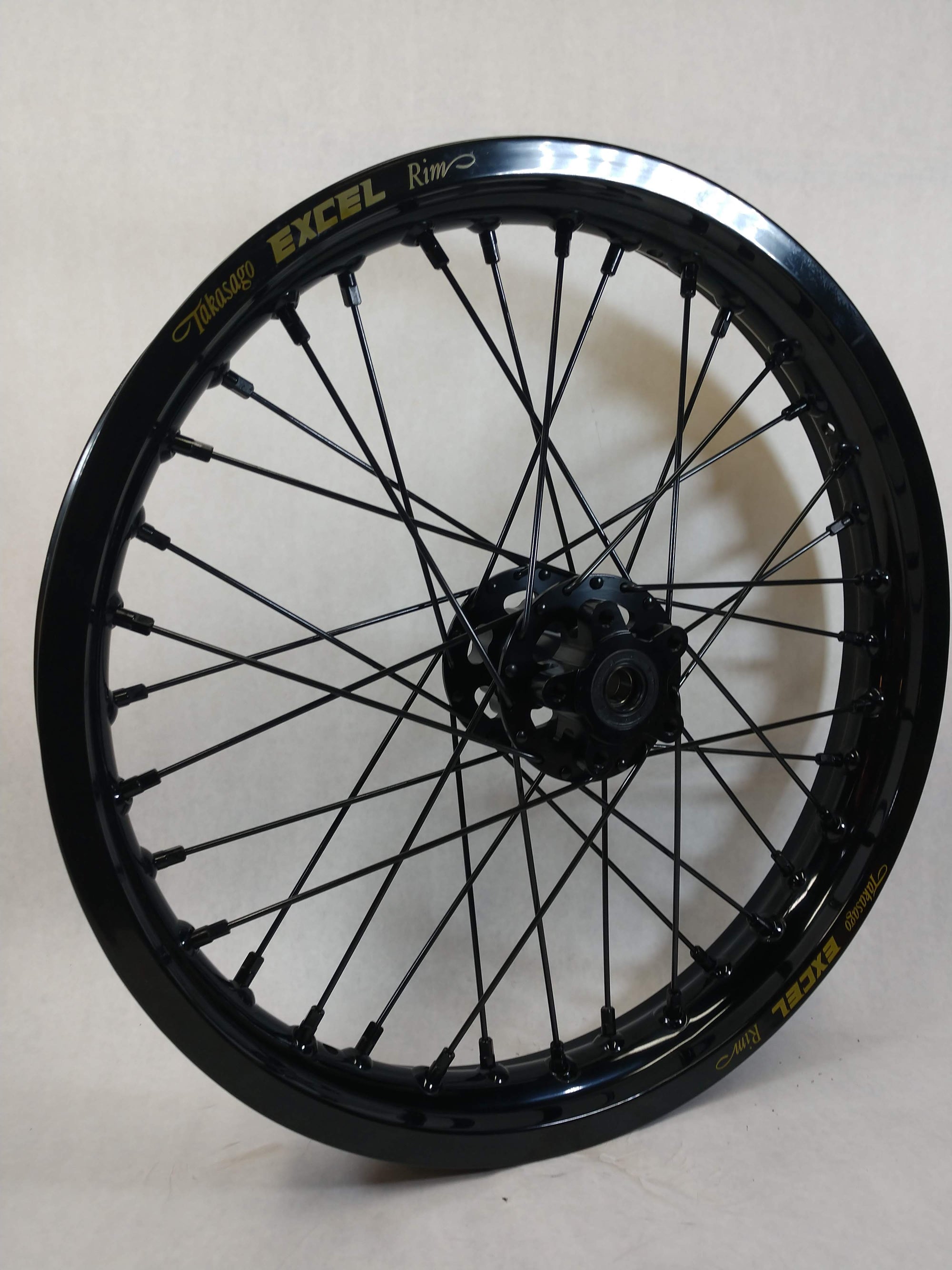Woody's custom rear wheel for Sur Ron e-bike. Featuring black Excel rim w/ black spokes/nipples and hub
