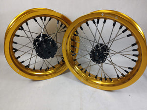Woody's custom wheels for Sur Ron e-bike in the 12" diameter, featuring gold rims, black hubs and black spoke-nipples