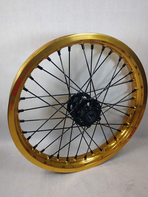 Woody's custom rear wheel for Sur Ron e-bike featuring gold Excel rim w/ black billet hub and black spoke-nipples.