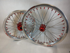 Woody's custom wheelset for Sur Ron e-bike featuring silver Excel rims w/ red billet hubs and red spoke-nipples.
