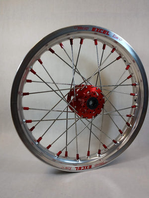 Woody's custom rear wheel for Sur Ron e-bike w/ silver Excel rim, red hub and red spoke-nipples.
